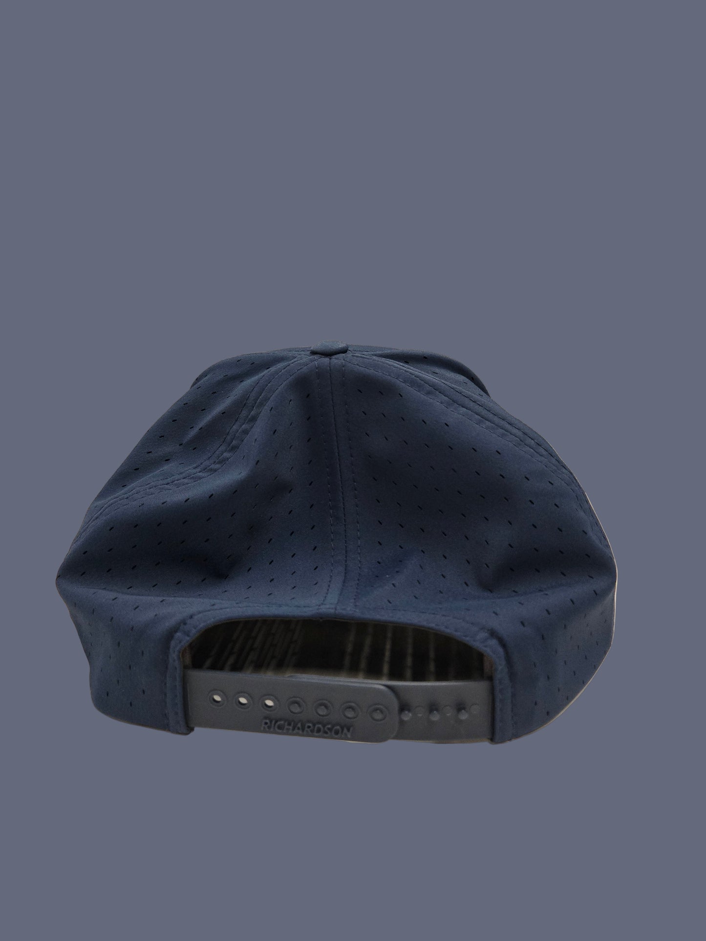 Navy blue cap with a textured surface on a neutral background