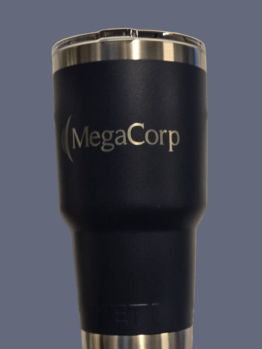 Black insulated tumbler with 'MegaCorp' branding on a metallic surface