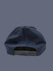Navy blue cap with a textured surface on a neutral background