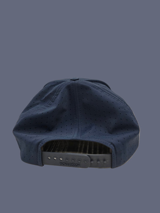 Navy blue cap with a textured surface on a neutral background